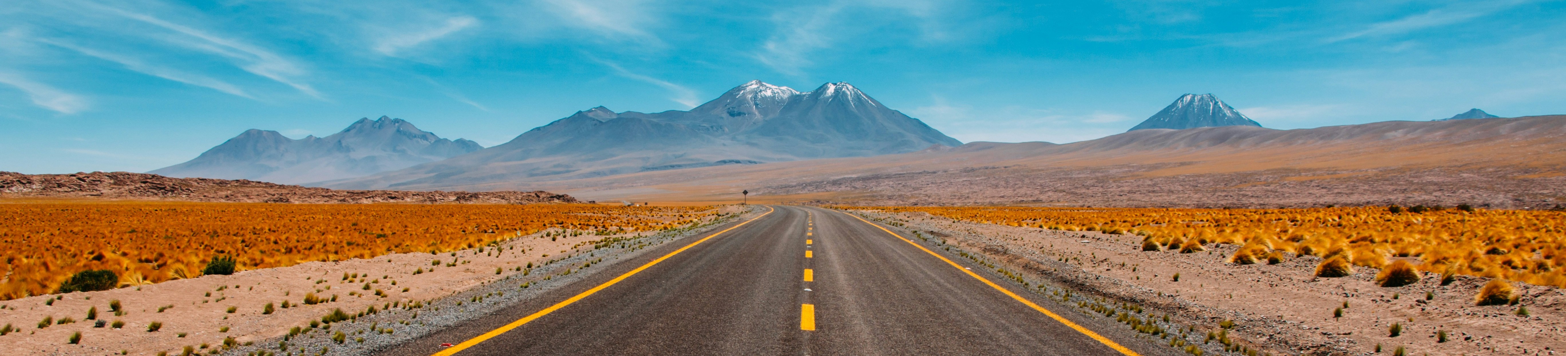 Lone road going to mountains in the desert